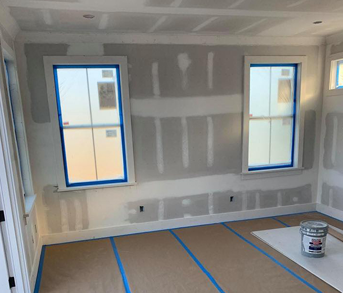 Fixing wall damage with drywall repair and stucco restoration services