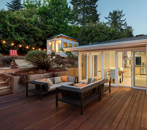 Refreshing outdoor wood surfaces with staining and protective coatings