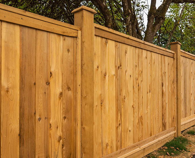Restoring fence appearance with durable paint and stain applications